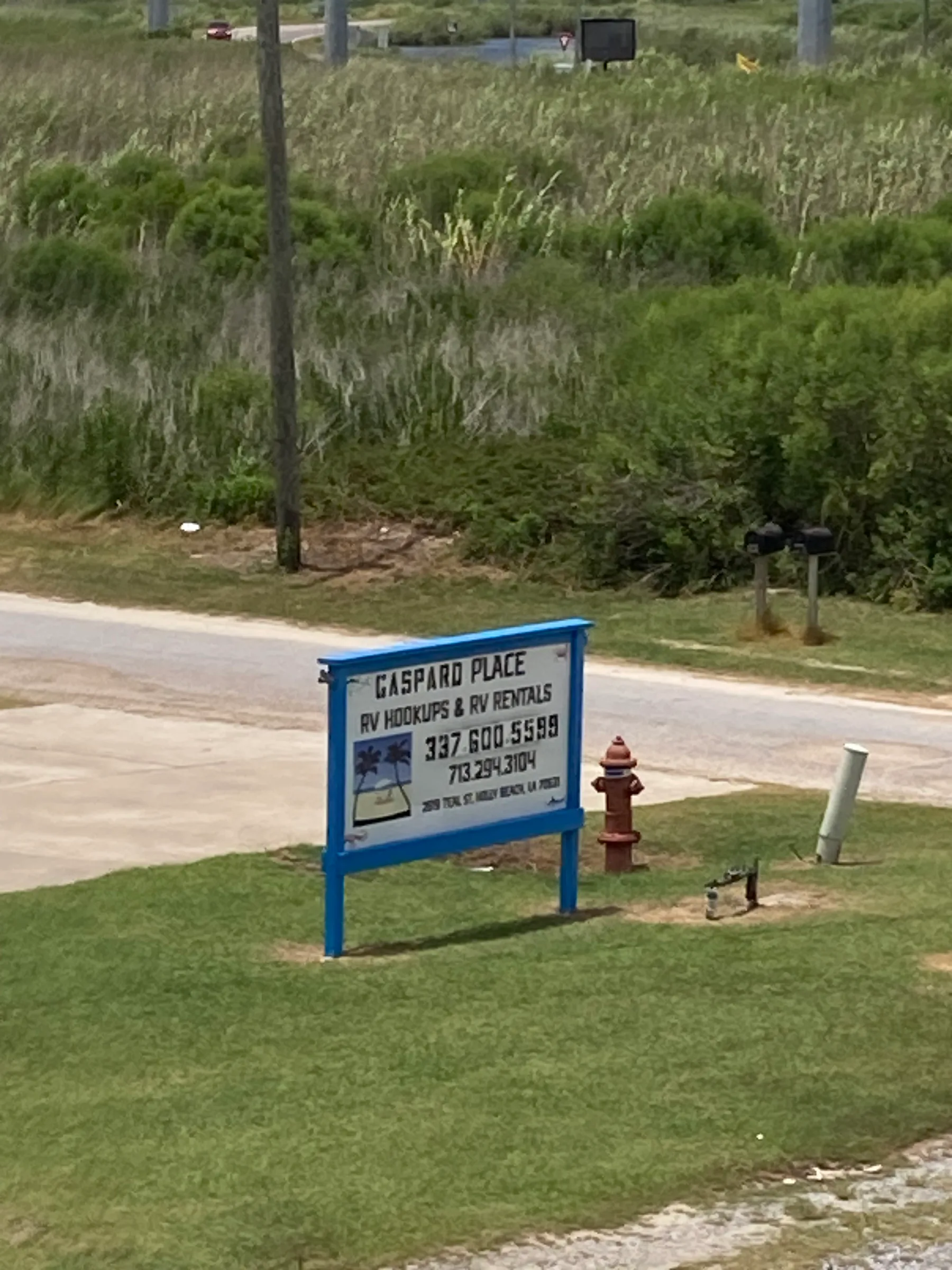 Gaspard Place roadside sign in Holly Beach